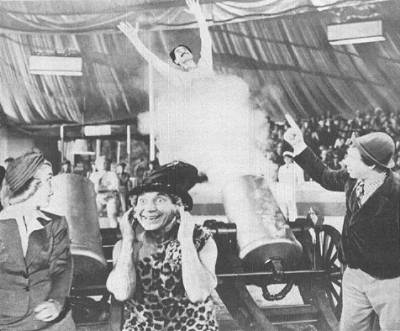 Groucho is fired from a cannon as Florence Rice, Harpo, and Chico look on in this publicity still from 'At The Circus.'